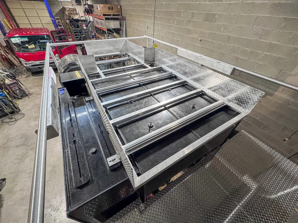 Diamond-plate body and step detail in production, photo 118 of 303.